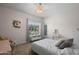 Cozy bedroom featuring a bed, vanity, dresser, and window bringing in lots of natural light at 3766 E Ringtail Way, Phoenix, AZ 85050