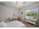 Bright bedroom features a work area with a decorative light fixture and large window views at 3766 E Ringtail Way, Phoenix, AZ 85050