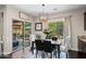 Elegant dining area with modern chandelier, backyard access, and stylish furnishings at 3766 E Ringtail Way, Phoenix, AZ 85050