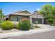 Charming single-story home with a well-manicured lawn, colorful bushes, and a two-car garage at 3766 E Ringtail Way, Phoenix, AZ 85050