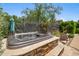 Backyard view of hot tub surrounded by a decorative wall and outdoor seating at 3766 E Ringtail Way, Phoenix, AZ 85050