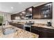 Well-equipped kitchen featuring granite countertops, stainless steel appliances, and ample cabinet space at 3766 E Ringtail Way, Phoenix, AZ 85050