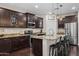 Gourmet kitchen featuring a large center island with seating, granite countertops, and stainless steel appliances at 3766 E Ringtail Way, Phoenix, AZ 85050