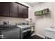 Laundry room with cabinets, washer, dryer, shelving, and utility sink at 3766 E Ringtail Way, Phoenix, AZ 85050