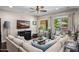 Inviting living room with a comfortable sectional sofa, stylish decor, and view to the outdoor pool area at 3766 E Ringtail Way, Phoenix, AZ 85050