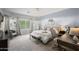 Serene main bedroom with a large window, neutral colors, chandelier, and a comfortable seating area at 3766 E Ringtail Way, Phoenix, AZ 85050