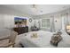Bright main bedroom featuring a dresser with TV, large window, chandelier, and a serene ambiance at 3766 E Ringtail Way, Phoenix, AZ 85050