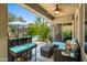 Relaxing covered patio with comfortable seating, ceiling fan, and view of the pool and backyard at 3766 E Ringtail Way, Phoenix, AZ 85050