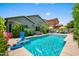 Beautiful pool with basketball hoop and patio furniture in backyard with green landscaping at 3766 E Ringtail Way, Phoenix, AZ 85050