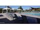 Community pool featuring lounge chairs, covered seating, and inviting blue water under a clear sky at 3766 E Ringtail Way, Phoenix, AZ 85050