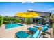 Inviting backyard with sparkling pool, lounge chairs, and a shaded patio area at 3766 E Ringtail Way, Phoenix, AZ 85050