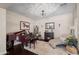 Cozy sitting room with a grand piano, fireplace, chaise lounge, and soft rug for added comfort at 3766 E Ringtail Way, Phoenix, AZ 85050