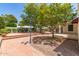 An outdoor backyard featuring brick landscaping, trees, and a well-maintained garden at 38 E Calavar Rd, Phoenix, AZ 85022