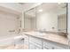 Bright bathroom featuring a vanity, marble countertop and a shower/tub combination at 38 E Calavar Rd, Phoenix, AZ 85022