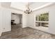Elegant dining room with a view, featuring a stylish chandelier at 38 E Calavar Rd, Phoenix, AZ 85022