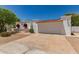 Charming single-story home with white exterior, barrel tile roof, and low-maintenance desert landscaping at 38 E Calavar Rd, Phoenix, AZ 85022