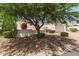 Attractive single-story home with white exterior, red awnings and roof, and a mature shade tree at 38 E Calavar Rd, Phoenix, AZ 85022