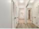Hallway features wood-look floors, neutral walls, and mirrored closet doors, enhancing the sense of space at 38 E Calavar Rd, Phoenix, AZ 85022