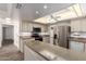Bright kitchen featuring stone counters, stainless steel appliances, and wood-look floors at 38 E Calavar Rd, Phoenix, AZ 85022