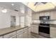 Open-concept kitchen with stainless steel appliances and generous counter space at 38 E Calavar Rd, Phoenix, AZ 85022