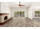 Living room with a stone fireplace and sliding doors leading to the backyard at 38 E Calavar Rd, Phoenix, AZ 85022