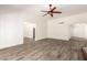 A spacious living room with beautiful wood floors, bright white walls, and attractive ceiling fan at 38 E Calavar Rd, Phoenix, AZ 85022