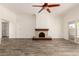 Spacious living room featuring a stone fireplace and sliding glass doors at 38 E Calavar Rd, Phoenix, AZ 85022