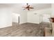 Bright, open living room with wood-look tile, white walls, and a ceiling fan at 38 E Calavar Rd, Phoenix, AZ 85022