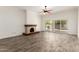 A spacious living room featuring elegant wood floors, a fireplace and a large sliding glass door at 38 E Calavar Rd, Phoenix, AZ 85022