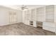 Bright living room with custom built-ins and wood-look tile flooring for a modern, inviting feel at 38 E Calavar Rd, Phoenix, AZ 85022