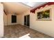 View of a covered patio with tiled floor and sliding door access to the house at 38 E Calavar Rd, Phoenix, AZ 85022