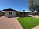Back exterior featuring a well-maintained backyard with turf and gravel at 3910 W Kings Ave, Phoenix, AZ 85053