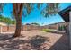 Spacious backyard with a large tree and a covered patio providing ample outdoor space at 3910 W Kings Ave, Phoenix, AZ 85053