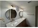 Bathroom featuring a double sink vanity with marble countertop and modern fixtures at 3910 W Kings Ave, Phoenix, AZ 85053