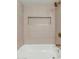 Elegant tile in a shower provides a luxurious feel with a built-in niche and bronze hardware at 3910 W Kings Ave, Phoenix, AZ 85053