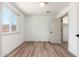 Light-filled bedroom featuring neutral walls, wood-look floors, and a closet with an open door at 3910 W Kings Ave, Phoenix, AZ 85053