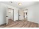An open-concept bedroom offers an ensuite and a closet, along with wood-look floors at 3910 W Kings Ave, Phoenix, AZ 85053