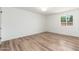 This bright bedroom features hardwood floors and a large window with views of the yard at 3910 W Kings Ave, Phoenix, AZ 85053