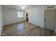Bright bedroom featuring wood-look flooring and natural light from the window at 3910 W Kings Ave, Phoenix, AZ 85053