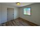 Bedroom featuring wood-look flooring and natural light from the window at 3910 W Kings Ave, Phoenix, AZ 85053