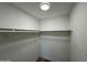 A walk-in closet with a double shelf for plenty of storage and clean white walls at 3910 W Kings Ave, Phoenix, AZ 85053