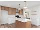 Well-lit kitchen showcases custom cabinetry, a stylish island, and stainless steel appliances at 3910 W Kings Ave, Phoenix, AZ 85053