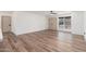 Large living room with wood-look floors, neutral walls, and lots of natural light at 3910 W Kings Ave, Phoenix, AZ 85053
