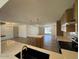 Open-concept living room with kitchen island and natural light at 3910 W Kings Ave, Phoenix, AZ 85053