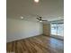 Bright living room with wood-look flooring, window view, and ample space at 3910 W Kings Ave, Phoenix, AZ 85053