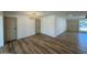 Well-lit living room with wood-look flooring and contemporary chandelier at 3910 W Kings Ave, Phoenix, AZ 85053