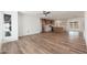 Bright living room boasts wood-look floors and an open layout to the kitchen at 3910 W Kings Ave, Phoenix, AZ 85053