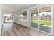 Bright living room features hardwood floors and expansive windows overlooking the backyard at 3910 W Kings Ave, Phoenix, AZ 85053