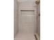 Modern walk-in shower with built-in niche and upscale tile finishes at 3910 W Kings Ave, Phoenix, AZ 85053