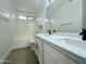 Bright bathroom featuring a dual sink vanity with black fixtures, tiled backsplash, and a shower-tub combination at 4050 E Agave Rd, Phoenix, AZ 85044